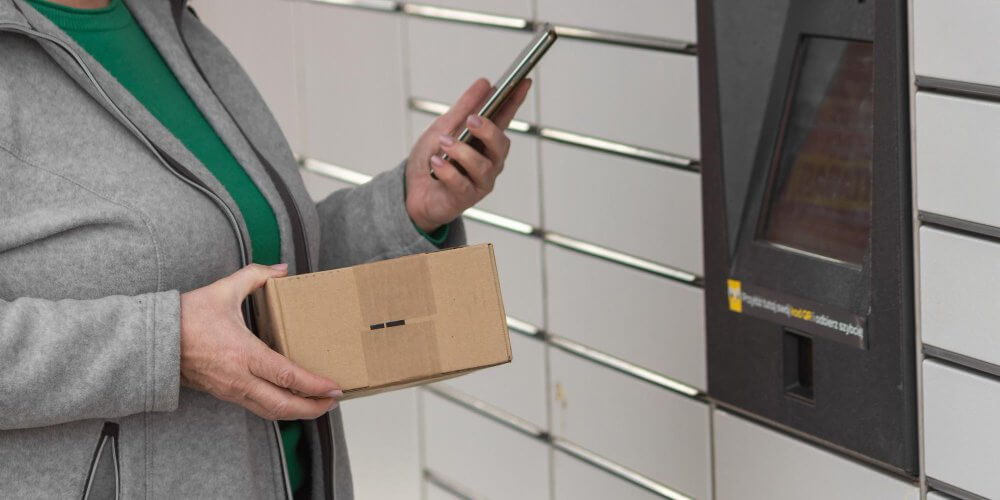 Kobieta odbierająca przesyłkę w paczkomacie tymczasowym